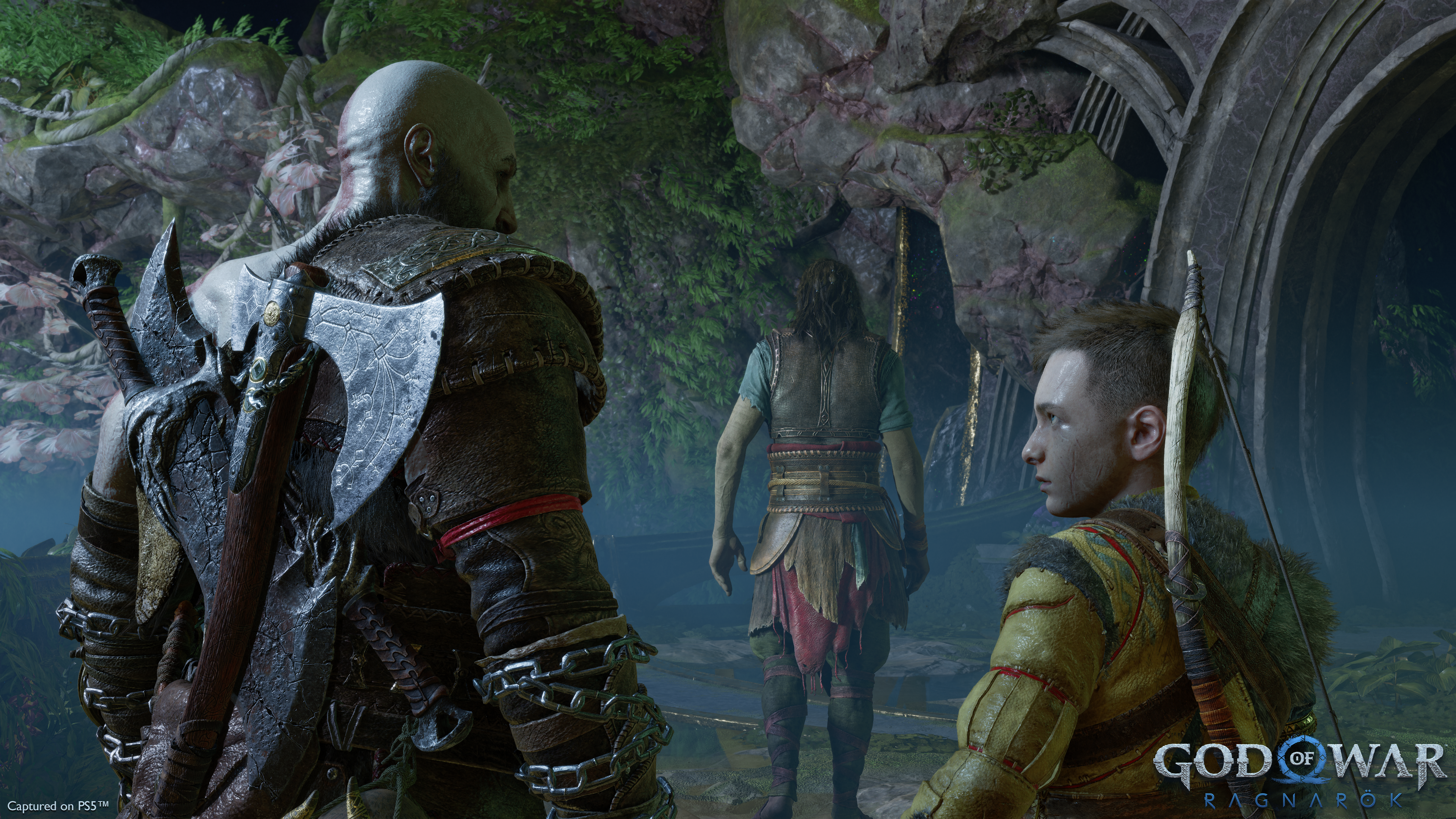 Kratos and Atreus share a look as they follow Tyr in God of War Ragnarok