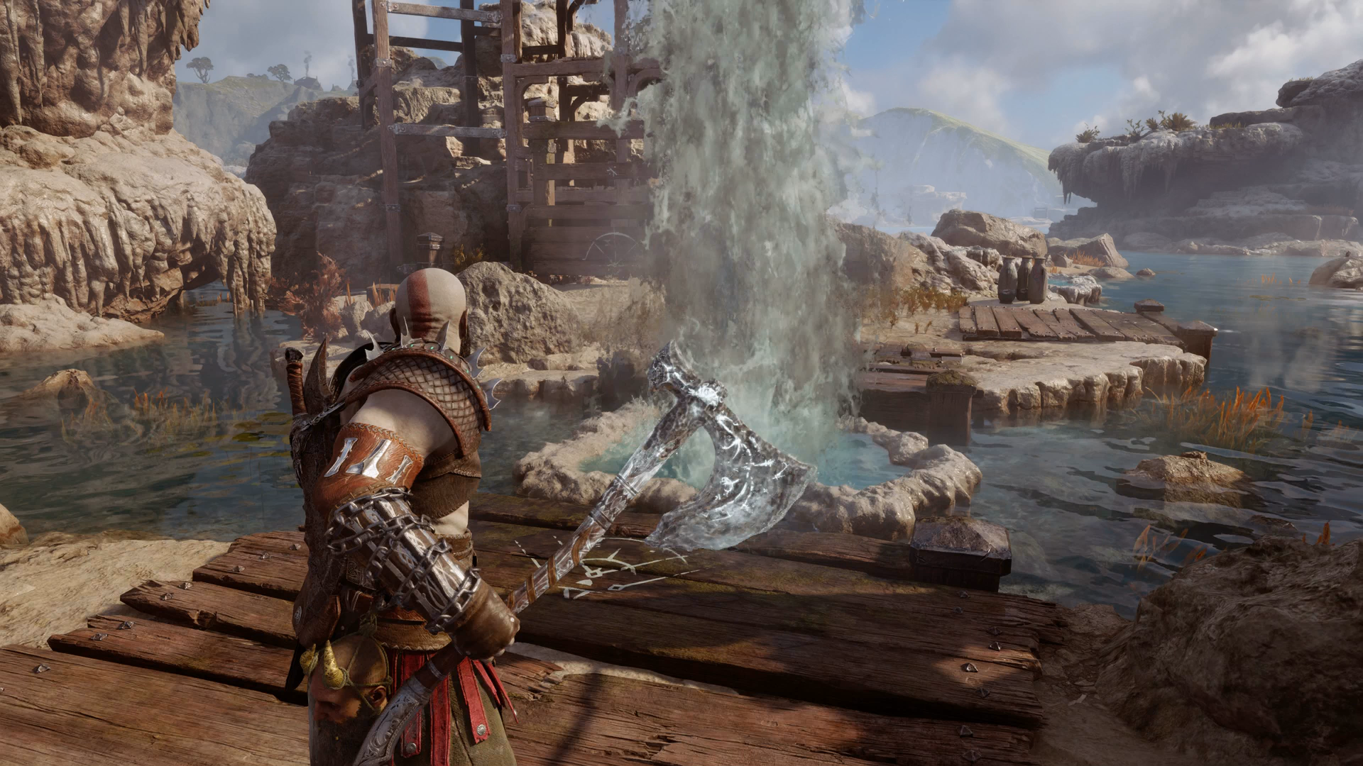 Kratos freezing a geyser with his axe in the Aurvangar Wetlands in God of War Ragnarok