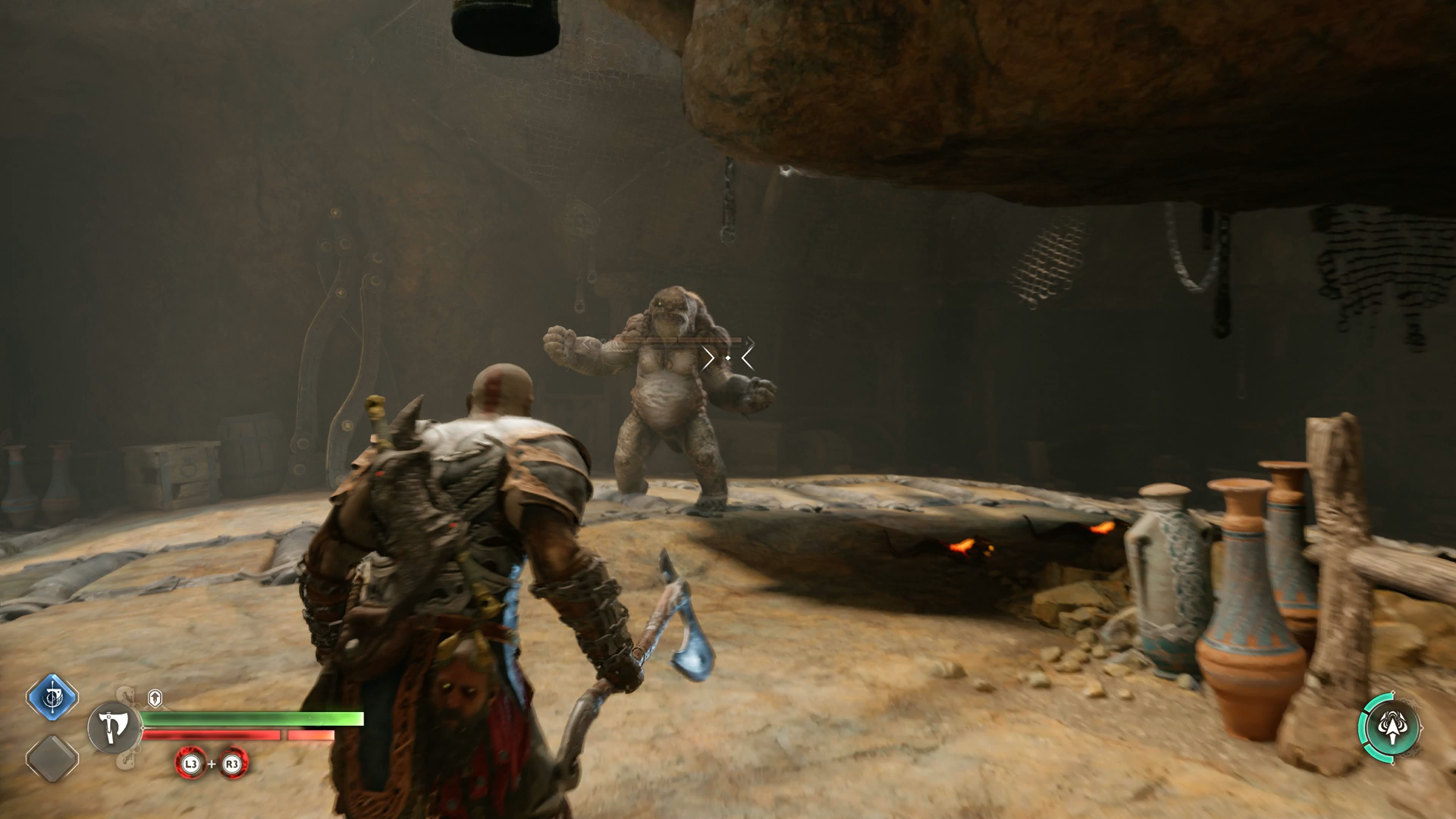 Kratos battling a cave troll in the Applecore in God of War Ragnarok