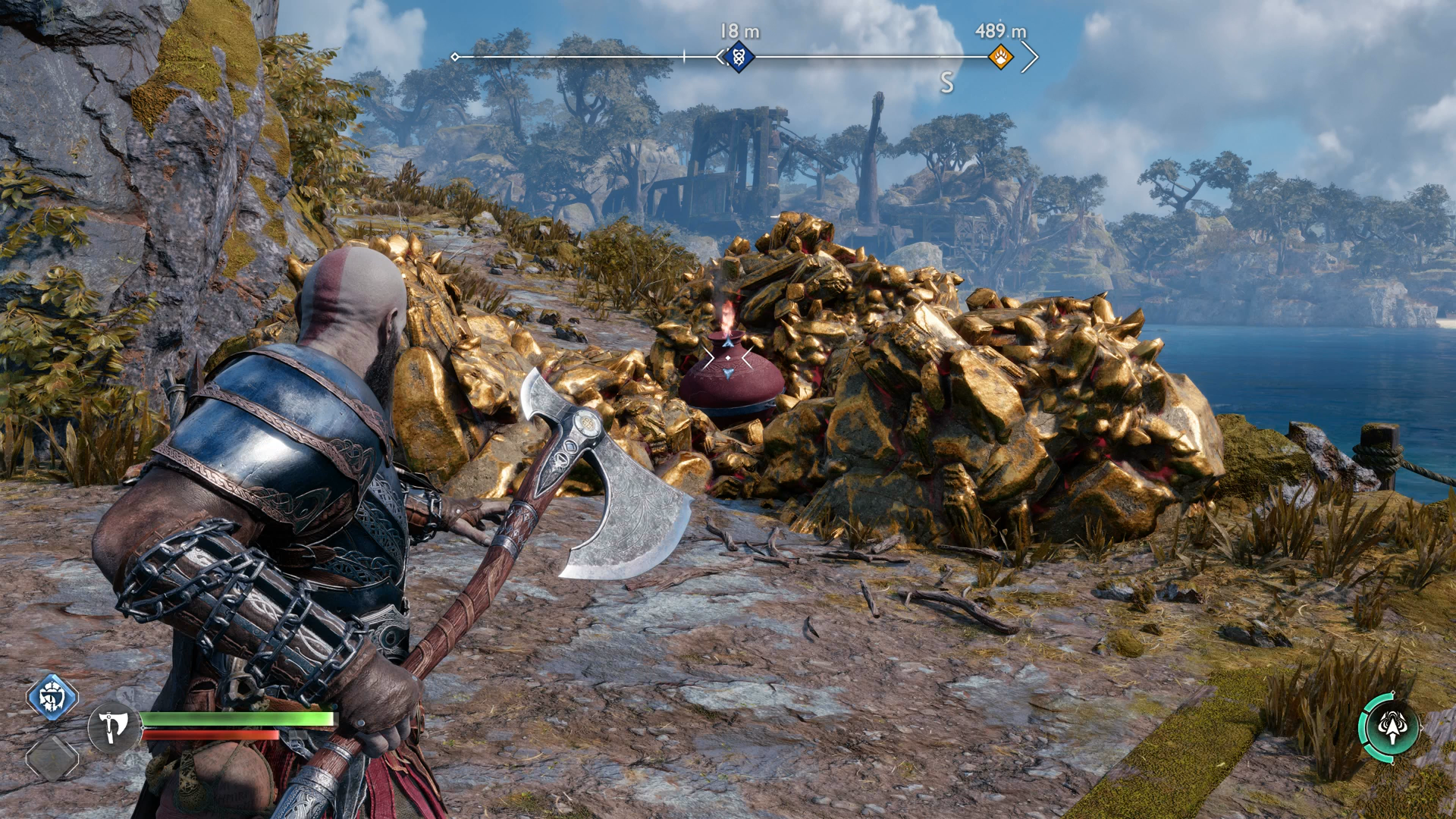Kratos readies an axe throw at the foot of a hill in God of War Ragnarok