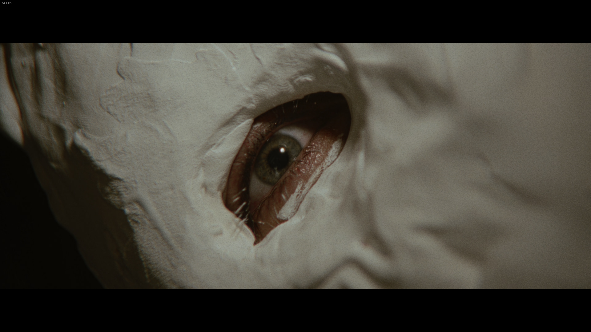 A close-up of Carl Goodman's eye while wearing a mask in second Marissa Marcel film, Minsky, in Immortality