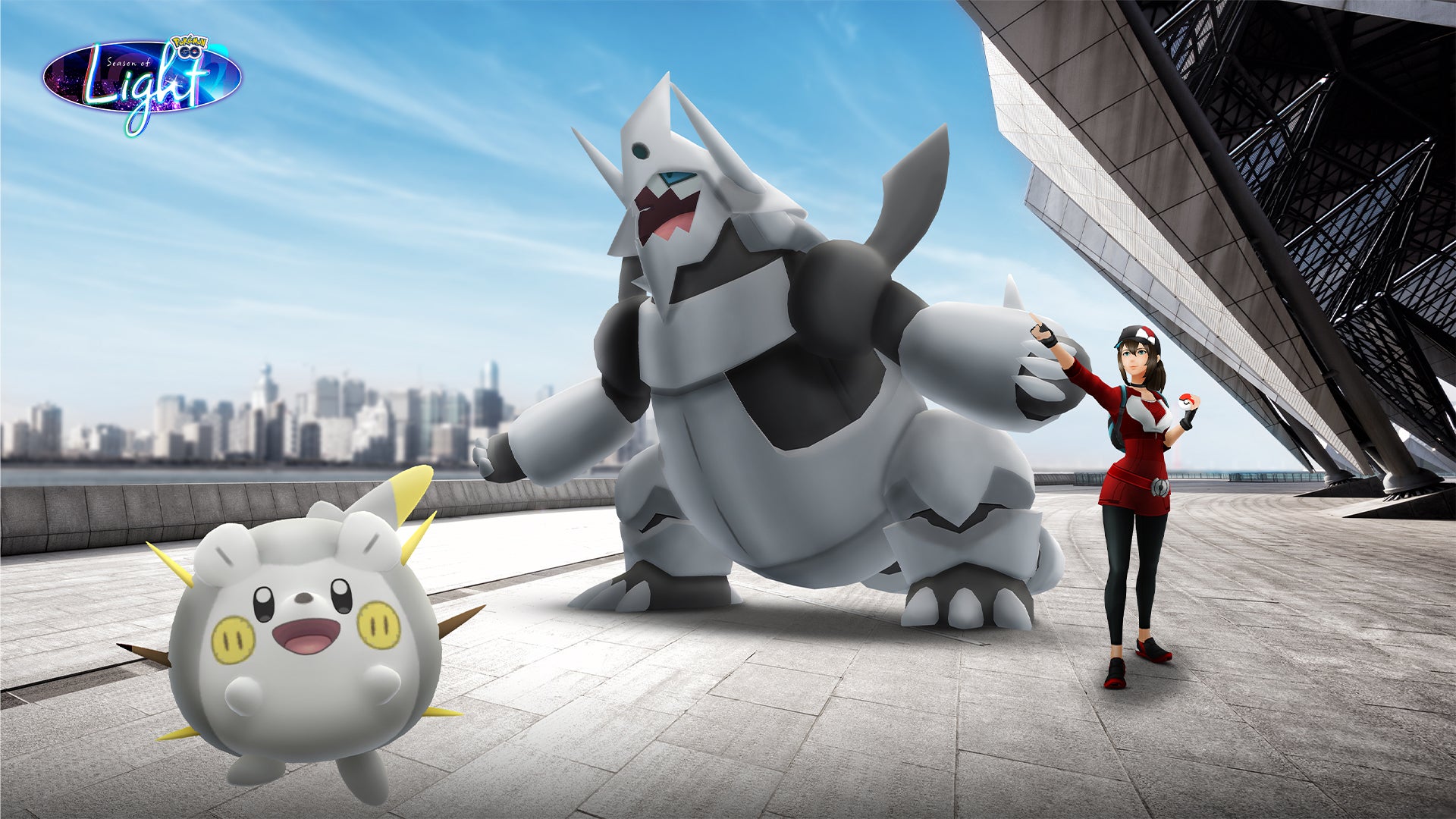 Togedemaru and Mega Aggron stand beside a Pokémon Trainer in Pokemon GO artwork.