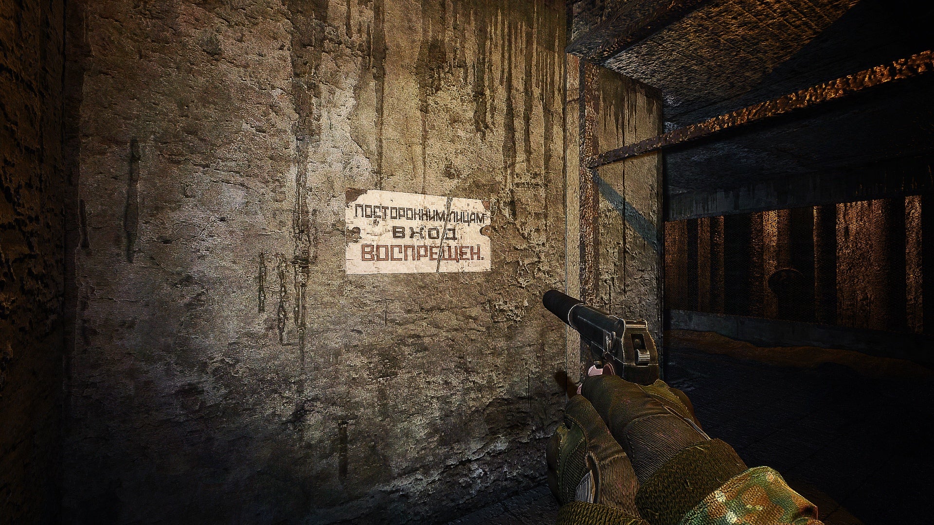 Player holding a pistol looks at a rusted sign in fan made overhaul mod for STALKER: Shadow of Chernobyl.