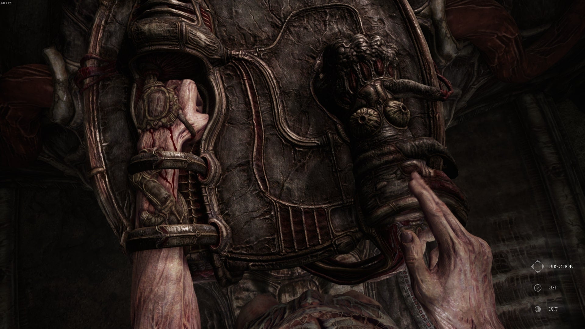 A pillar that requires the player to insert both of their arms inside is shown in Scorn's Act 1