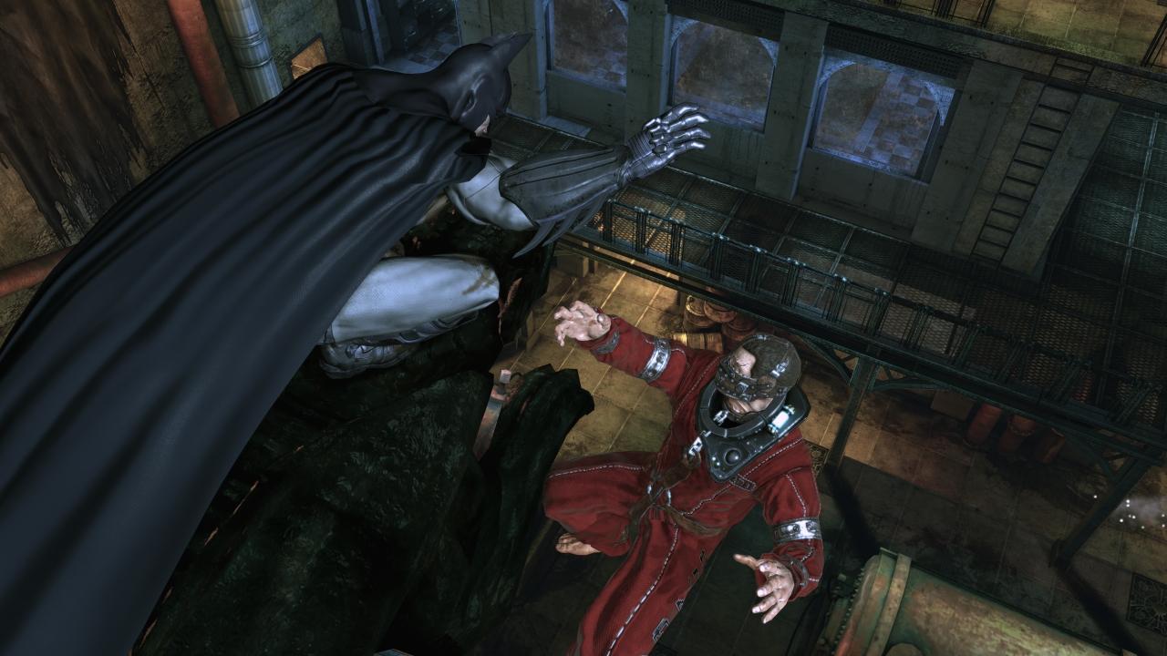 Batman suspends a villain from a gargoyle in Batman: Arkham Asylum