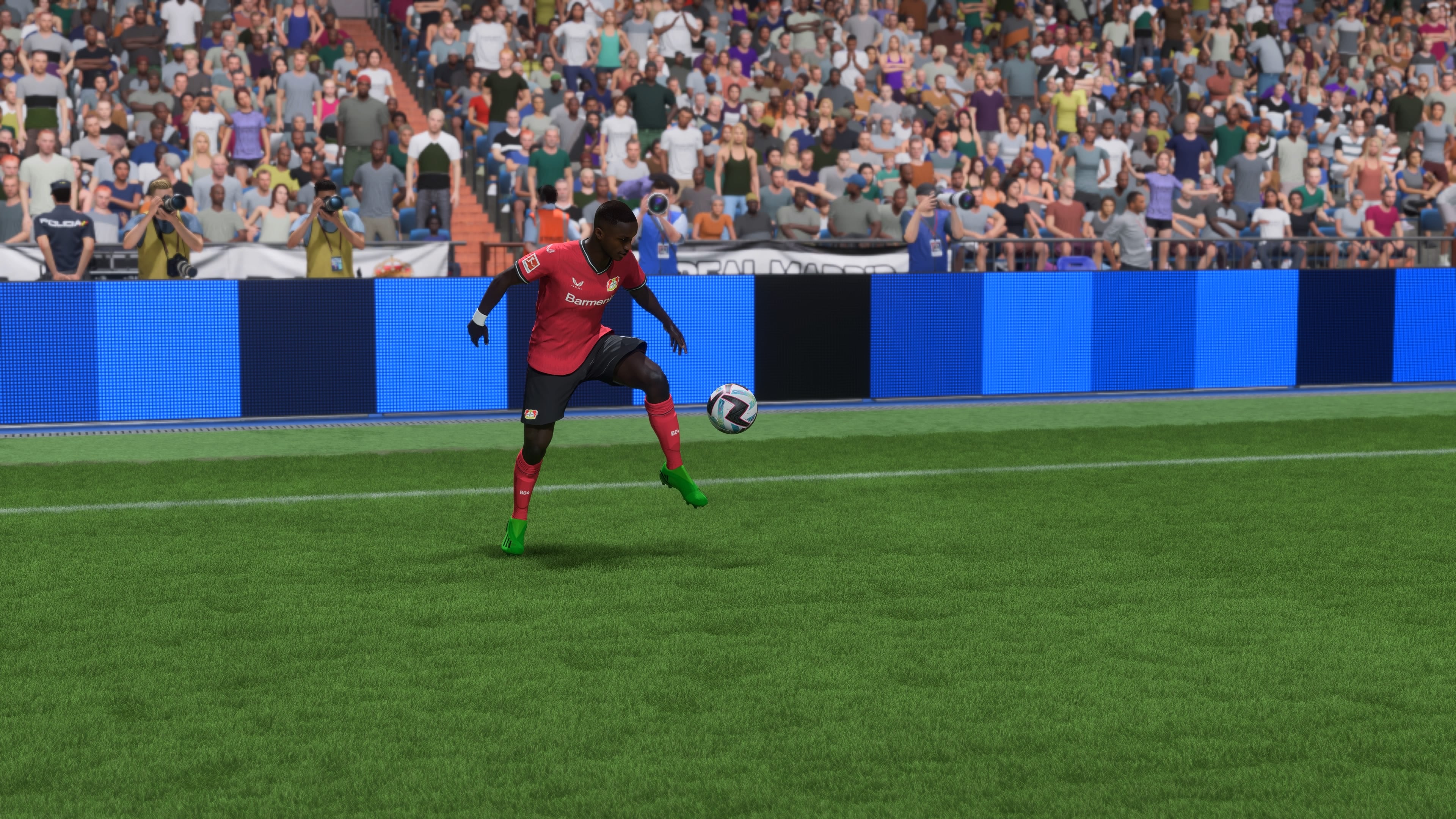 Bayer Leverkusen's Moussa Diaby controls a bouncing ball on the touchline in FIFA 23