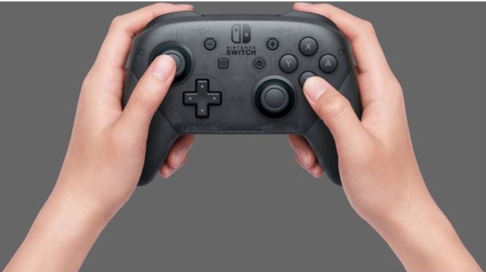 Person holding Nintendo Switch Pro Controller