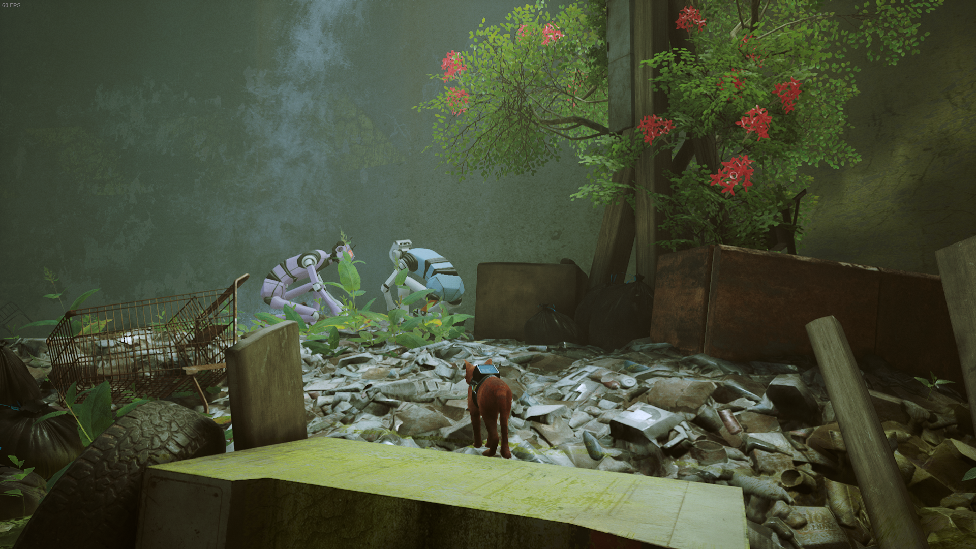 The cat of Stray looks at two robots scavenging beside a tree with red flowers in Antvillage.