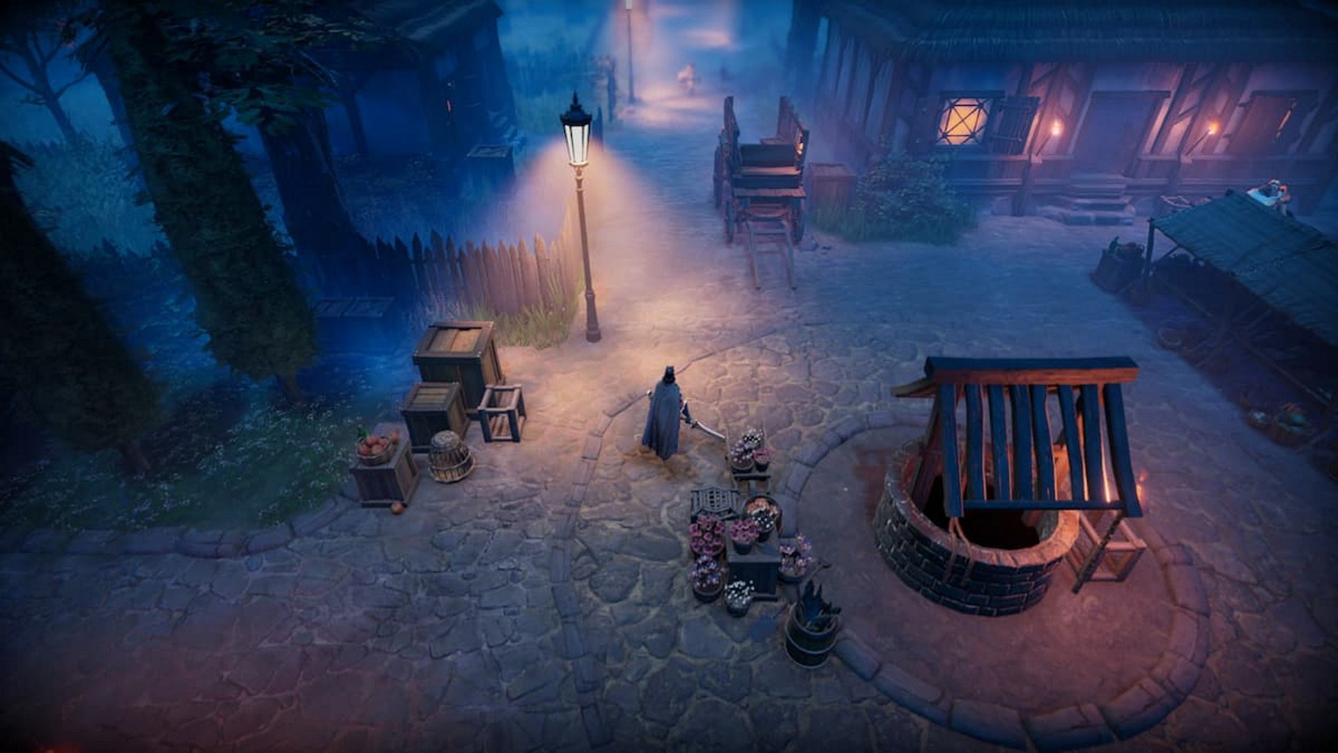 V Rising, a character is standing in the middle of a village at night holding a weapon, there's a Well on the right, some flowers behind them, boxes to the left, and a wooden cart next to a house in front of them