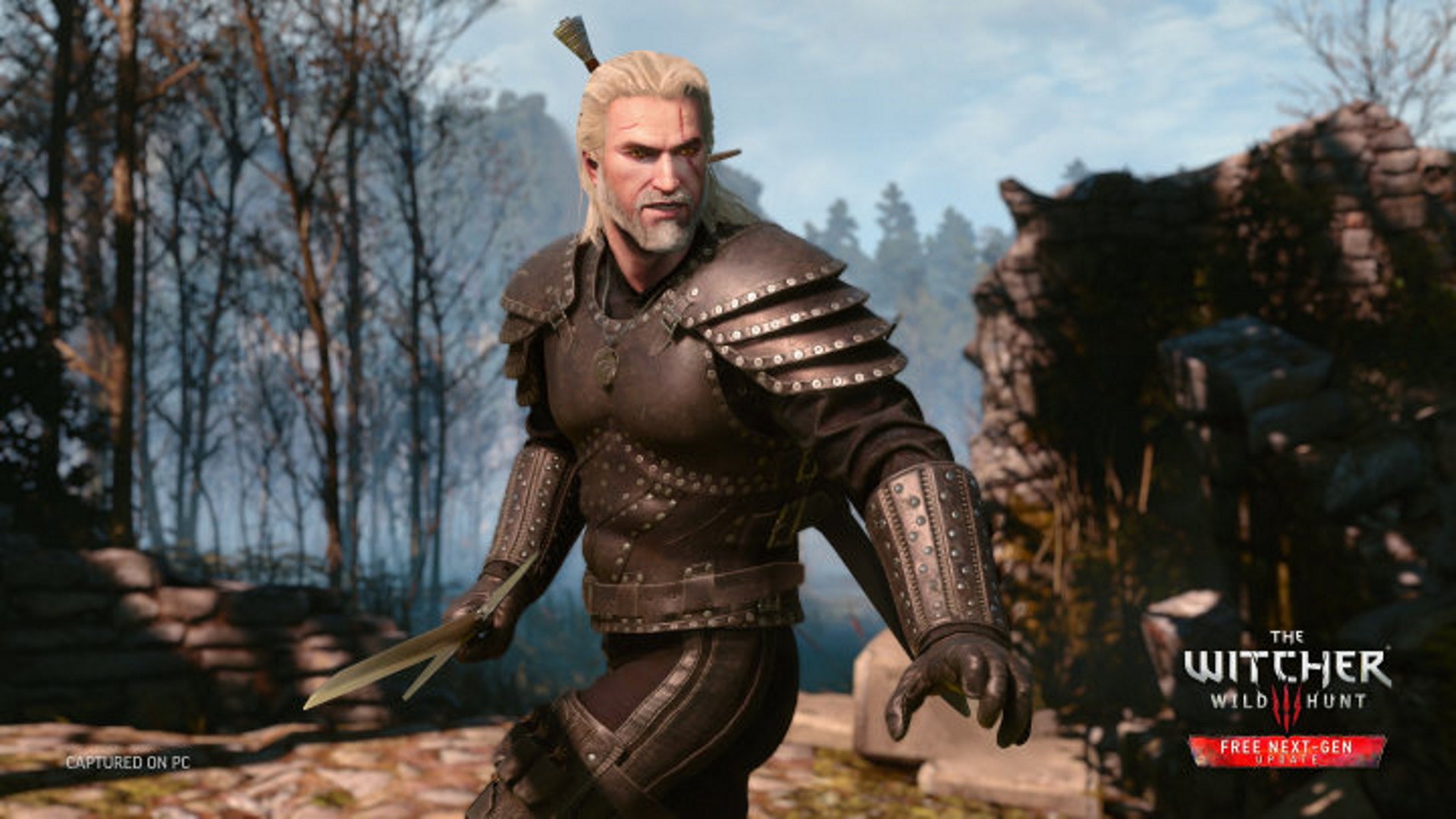 The Witcher 3 best weapons and armor: A white man with long white hair, wearing black plate armor, stands poised with a sword, ready to attack. He's in a barren field with scorched trees behind him